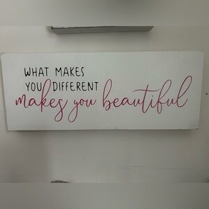 a canvas that says “ what makes you different makes you beautiful”